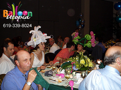 A Table full of adults enjoying the fun created by balloon entertainment